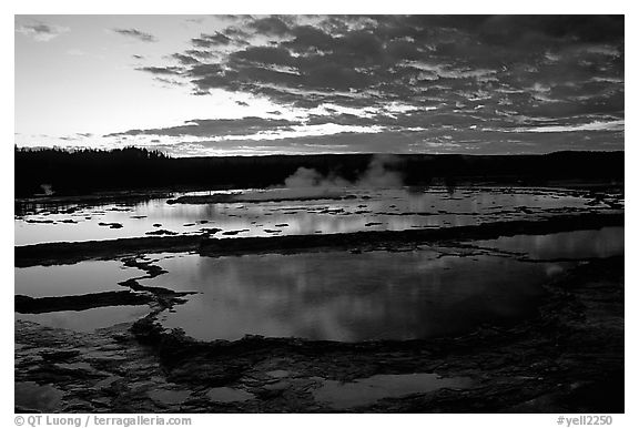 Great Fountain geyser and colorful clouds at sunset. Yellowstone National Park, Wyoming, USA.