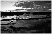Great Fountain geyser and colorful clouds at sunset. Yellowstone National Park ( black and white)