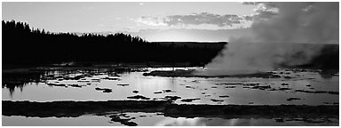Steam rising in geyser pool at sunset. Yellowstone National Park (Panoramic black and white)