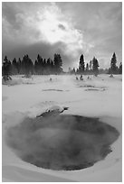 Thermal pool and dark clouds, winter. Yellowstone National Park, Wyoming, USA. (black and white)