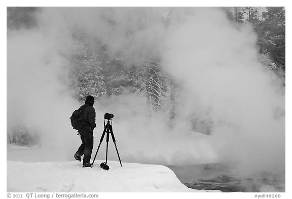 Photographer standing next to hot springs. Yellowstone National Park (black and white)