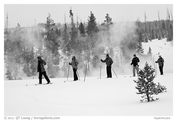 Skiers and thermal steam. Yellowstone National Park, Wyoming, USA.