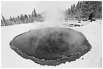 Hiker at Morning Glory Pool, winter. Yellowstone National Park, Wyoming, USA. (black and white)