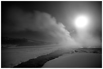 Run-off and geyser, steam obscuring moon, Old Faithful. Yellowstone National Park, Wyoming, USA. (black and white)