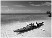 Woman reclining in kayak on shallow waters,  Elliott Key. Biscayne National Park, Florida, USA. (black and white)