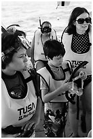 Family preparing for snorkeling. Biscayne National Park, Florida, USA. (black and white)