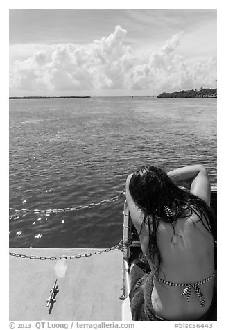 Woman relaxes on snorkeling boat as it enters Caesar Creek. Biscayne National Park (black and white)