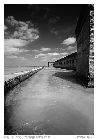 Fort Jefferson moat and massive brick wall on a sunny dayl. Dry Tortugas National Park (black and white)