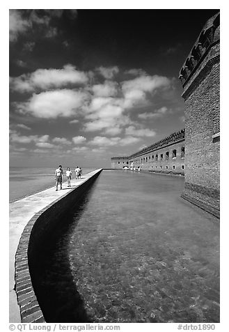 Tourists walking on seawall. Dry Tortugas National Park, Florida, USA.