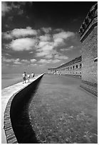 Tourists walking on seawall. Dry Tortugas National Park ( black and white)