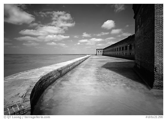 Moat with turquoise waters, seawall, and fort. Dry Tortugas National Park (black and white)
