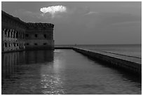 Moat, fort, bright cloud at dawn. Dry Tortugas National Park, Florida, USA. (black and white)