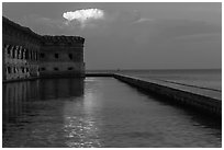 Moat, fort, bright cloud at dawn. Dry Tortugas National Park ( black and white)