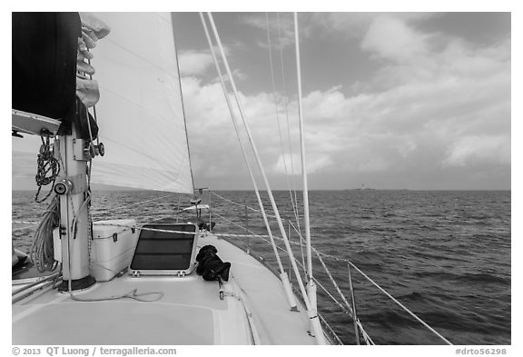 Loggerhead lighthouse seen from sailboat under blue skies. Dry Tortugas National Park (black and white)