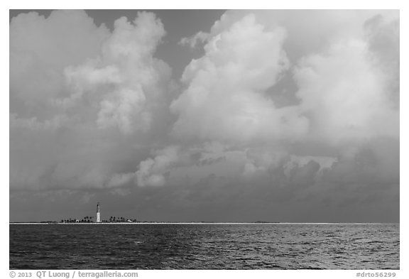 Loggerhead key and lighthouse under tropical clouds. Dry Tortugas National Park, Florida, USA.