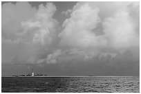 Loggerhead key and lighthouse under tropical clouds. Dry Tortugas National Park, Florida, USA. (black and white)
