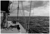 Loggerhead lighthouse seen from sailboat under dark skies. Dry Tortugas National Park, Florida, USA. (black and white)