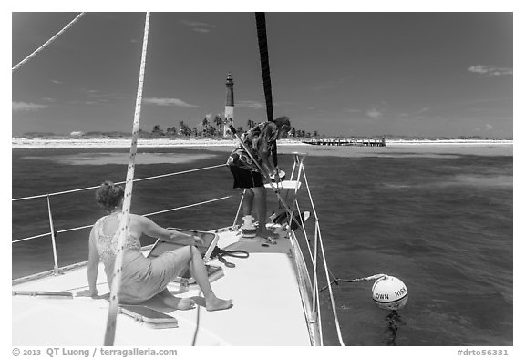 Sailors hooking mooring buoy at Loggerhead Key. Dry Tortugas National Park, Florida, USA.