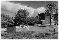 Children walking in campground. Dry Tortugas National Park, Florida, USA. (black and white)