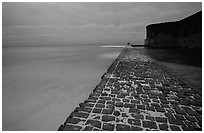 Brick seawall at dusk during a storm. Dry Tortugas National Park, Florida, USA. (black and white)