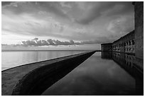 Fort Jefferson seawall, moat and walls at sunset. Dry Tortugas National Park, Florida, USA. (black and white)