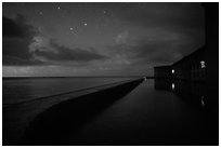 Fort Jefferson at night with stars and light from storm. Dry Tortugas National Park, Florida, USA. (black and white)
