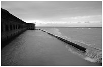 Seawall and moat with waves on stormy day. Dry Tortugas National Park ( black and white)