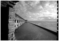Fort Jefferson wall and moat, framed by cannon window. Dry Tortugas National Park, Florida, USA. (black and white)
