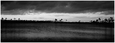 Sunset over lake with dark clouds. Everglades  National Park (Panoramic black and white)