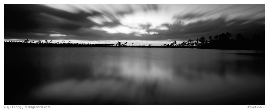 Dark clouds in motion at sunset over lake. Everglades National Park (black and white)