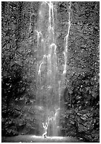 Tourist refreshes herself at the base of Waimoku Falls. Haleakala National Park ( black and white)