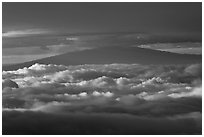 Mauna Kea between clouds, seen from Halekala summit. Haleakala National Park, Hawaii, USA. (black and white)