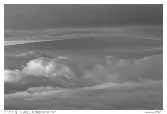 Mauna Loa between clouds, seen from Halekala summit. Haleakala National Park, Hawaii, USA.