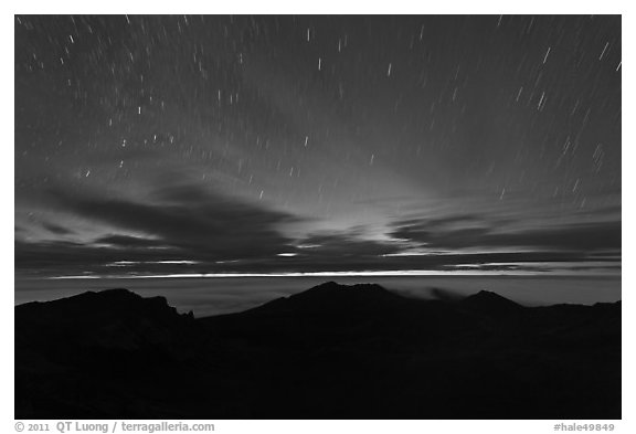 Crater ridge and stars in motion at night. Haleakala National Park, Hawaii, USA.