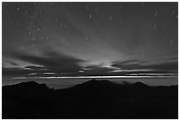 Crater ridge and stars in motion at night. Haleakala National Park, Hawaii, USA. (black and white)