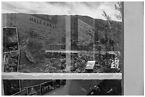 Haleakala slopes and native garden with signs, Park Headquarters Visitor Center window reflexion. Haleakala National Park ( black and white)