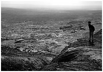 Hiker on top of Mauna Ulu crater. Hawaii Volcanoes National Park, Hawaii, USA. (black and white)