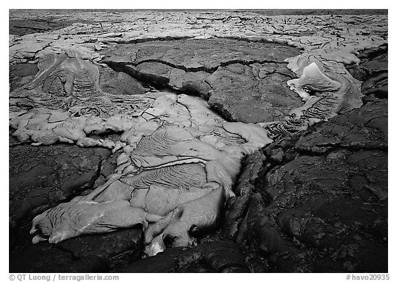 New lava flowing over layer of hardened lava. Hawaii Volcanoes National Park (black and white)