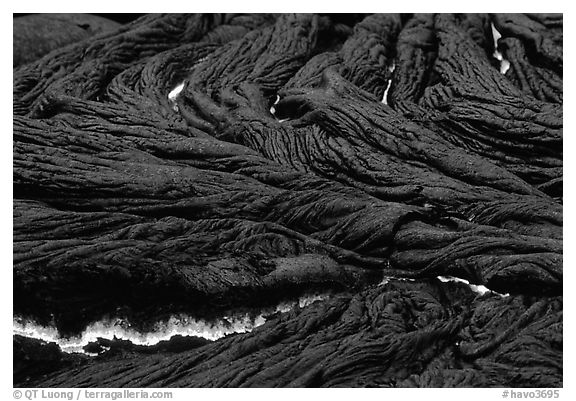 Close-up of ripples of flowing pahoehoe lava at dusk. Hawaii Volcanoes National Park, Hawaii, USA.