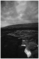 Molten Lava glows at dawn. Hawaii Volcanoes National Park, Hawaii, USA. (black and white)