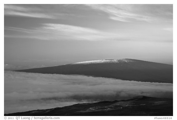 Snowy Mauna Loa above clouds at sunrise. Hawaii Volcanoes National Park (black and white)
