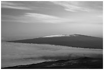 Snowy Mauna Loa above clouds at sunrise. Hawaii Volcanoes National Park, Hawaii, USA. (black and white)