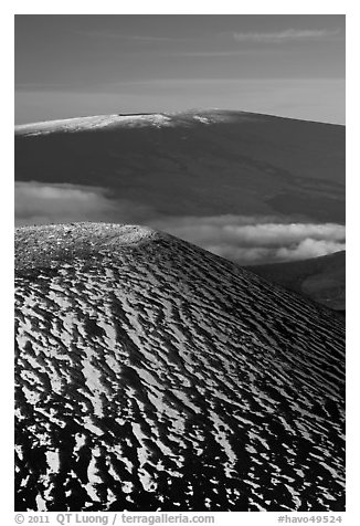 Snowy cinder cone and Mauna Loa summit. Hawaii Volcanoes National Park, Hawaii, USA.