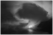 Lava steam swirls above ocean at dusk. Hawaii Volcanoes National Park ( black and white)