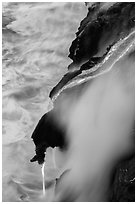 Ribbons of lava flow into the Pacific Ocean. Hawaii Volcanoes National Park, Hawaii, USA. (black and white)