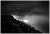 Lava makes contact with ocean on a stary night. Hawaii Volcanoes National Park ( black and white)