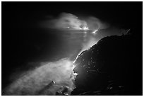 Streams of lava flow into Pacific Ocean. Hawaii Volcanoes National Park ( black and white)