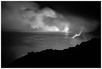 Hydrochloric steam clouds glow by lava light on coast. Hawaii Volcanoes National Park, Hawaii, USA. (black and white)