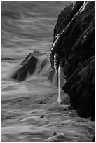 Hot lava drips into ocean waters at dawn. Hawaii Volcanoes National Park, Hawaii, USA. (black and white)