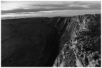 Cliffs bordering Mauna Loa summit caldera from rim at sunrise. Hawaii Volcanoes National Park, Hawaii, USA. (black and white)